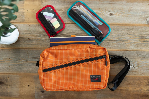 Clear Mystery Pouches clipped into a Packing Cube Shoulder Bag